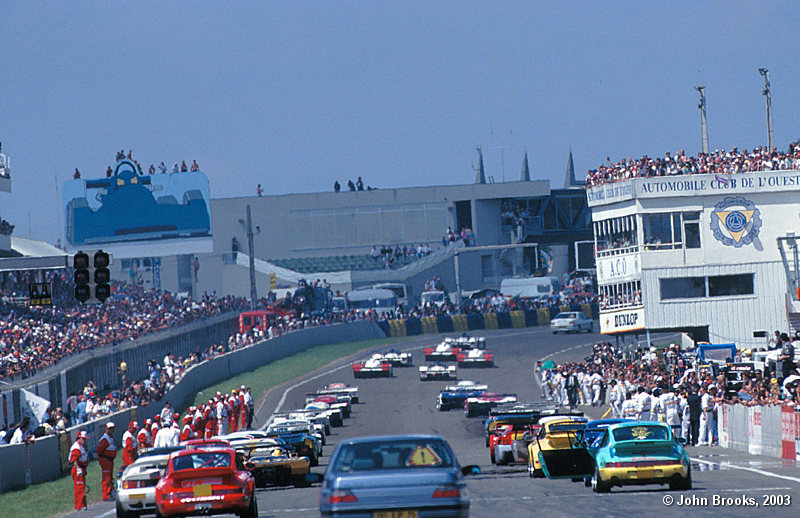 Over the hills and far away...........a 406 leads the field away on the parade lap