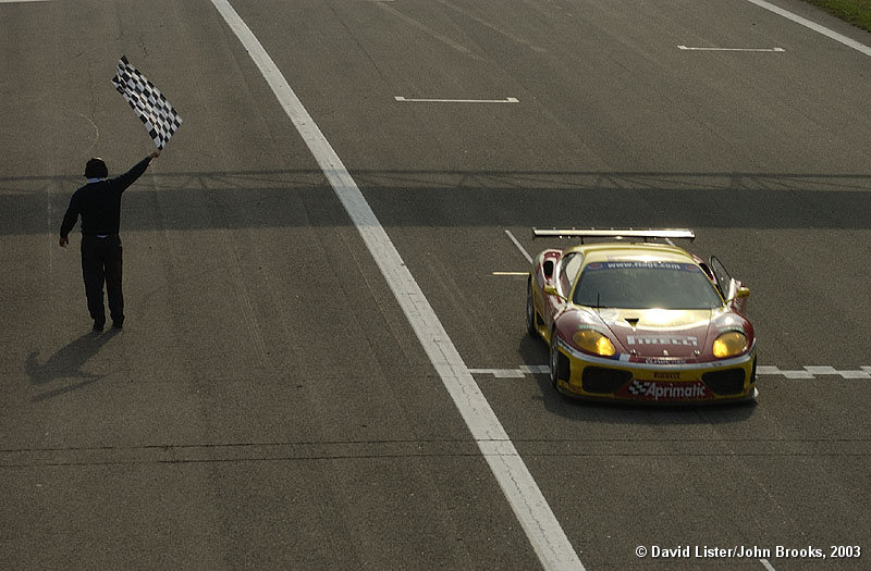 Andrea Bertollini takes the flag in the JMB Racing 360 Modena