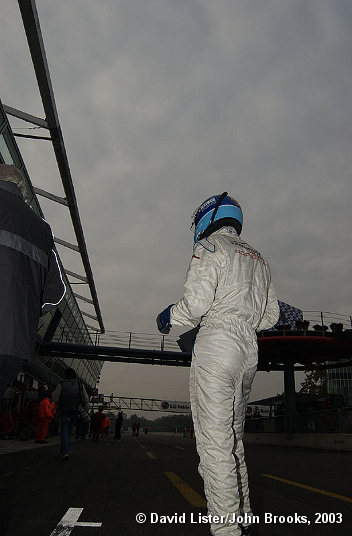 Mark Lieb awaits the arrival of the #50 Freisinger Porsche during  morning warm-up