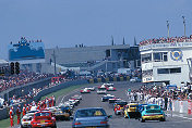 Over the hills and far away...........a 406 leads the field away on the parade lap